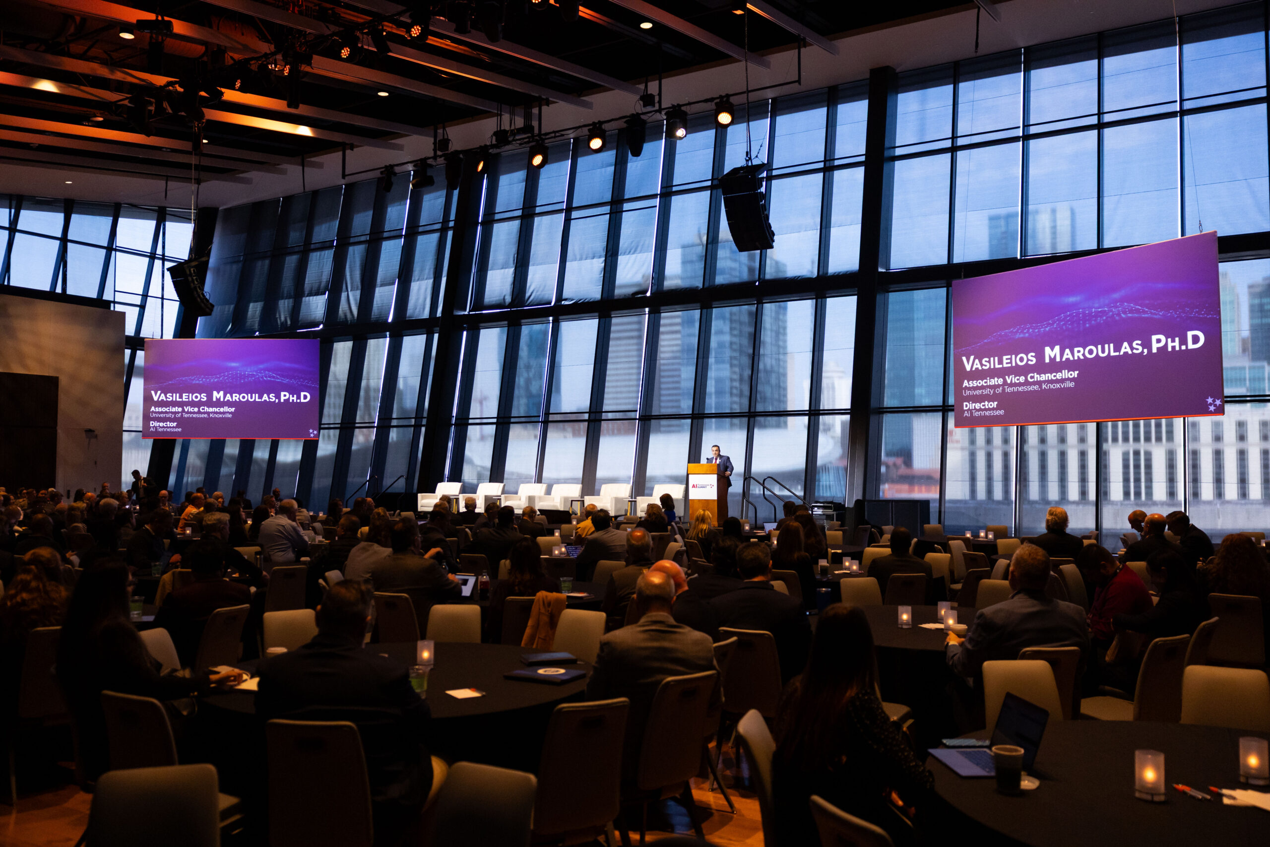 A speaker addresses the audience from the main stage podium during the Tennessee AI Summit.